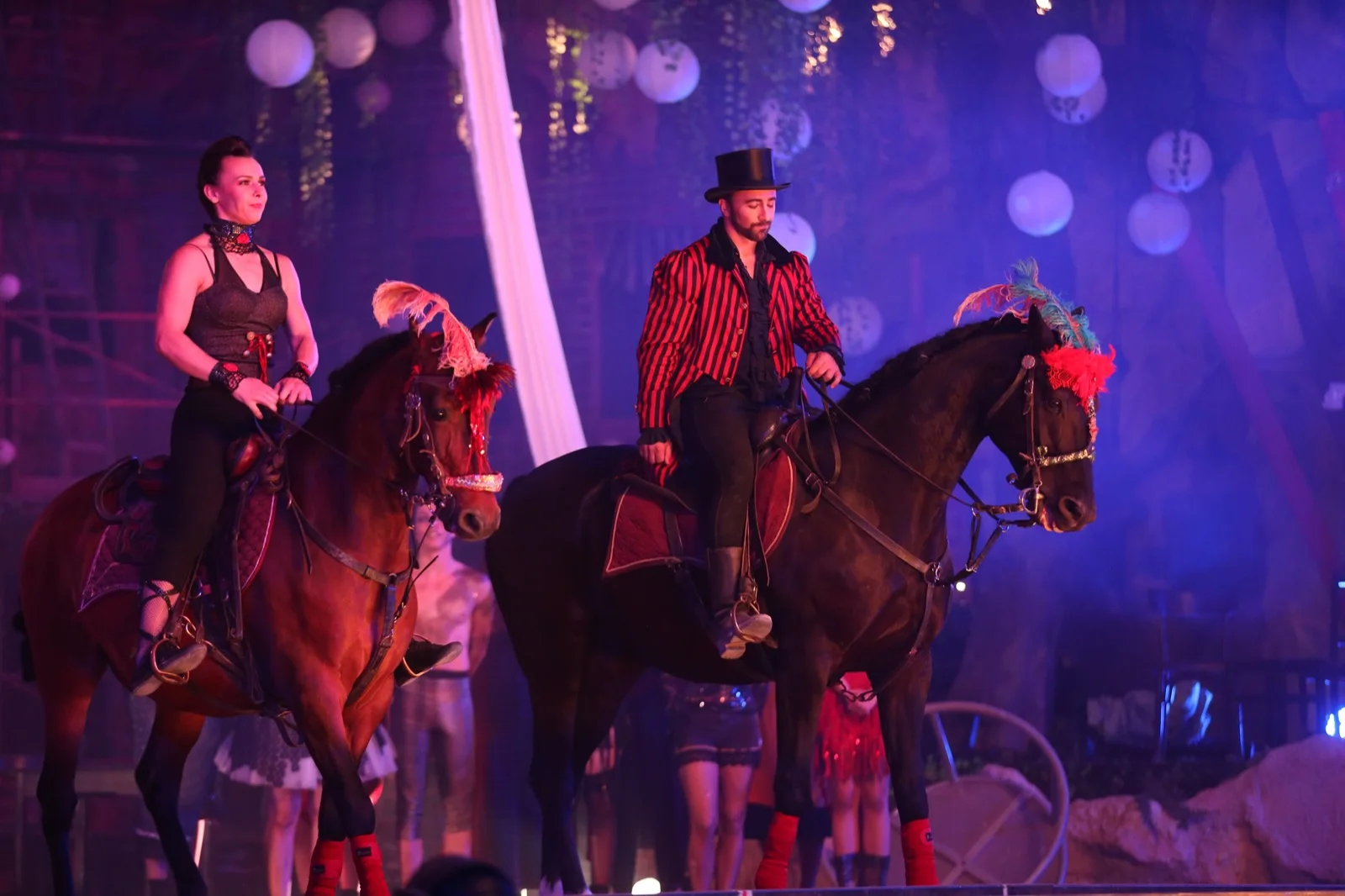 Horse acts with two performers on a show stage